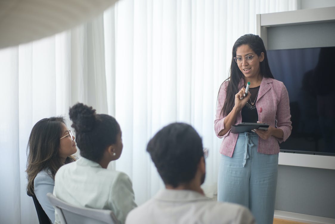 Woman explaining the benefits of AI to her colleagues.