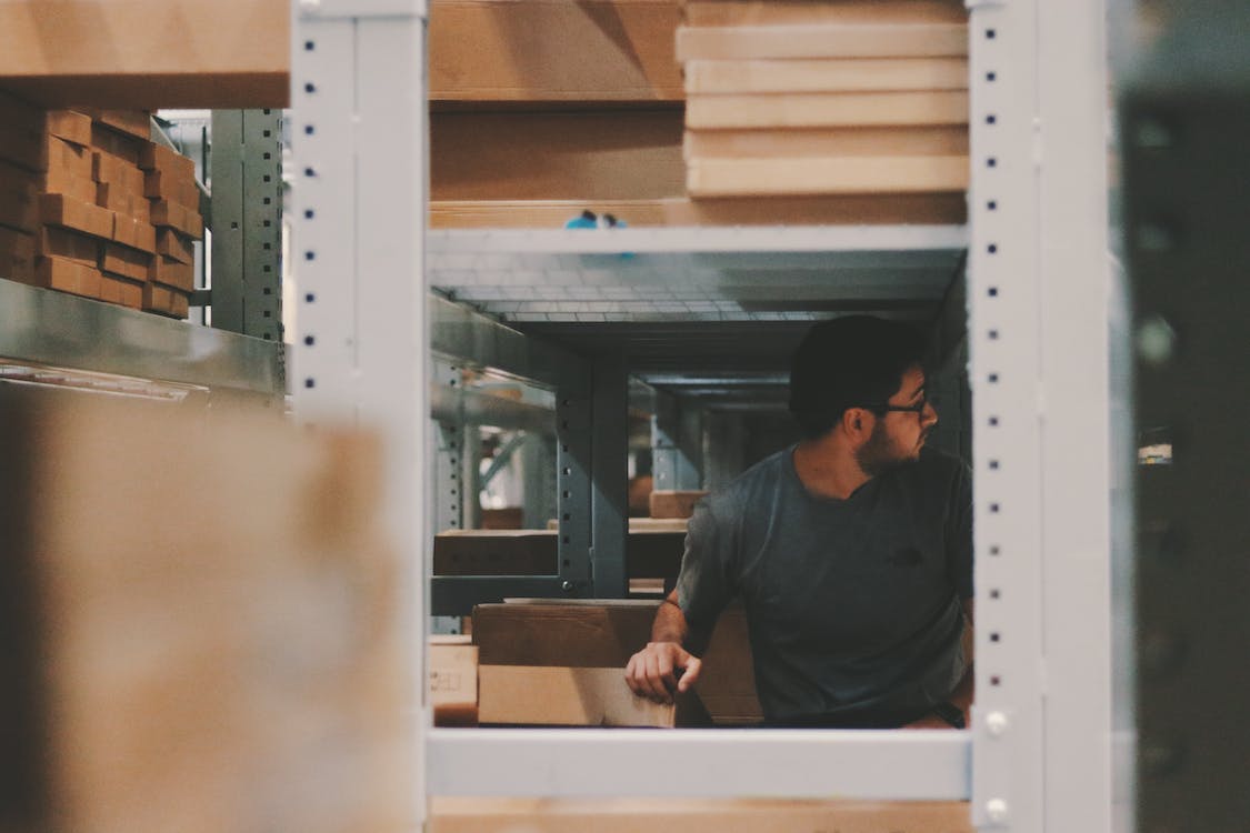 Person looking through warehouse shelves