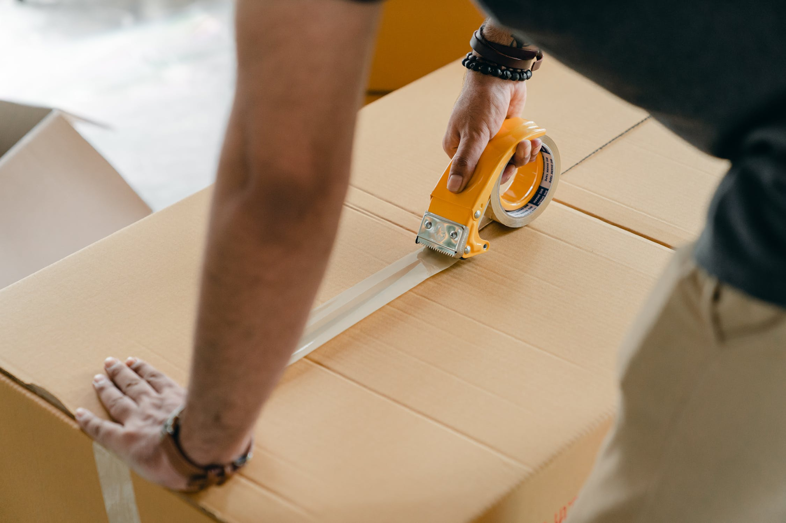 A fulfillment center worker packing a dropshipping order.