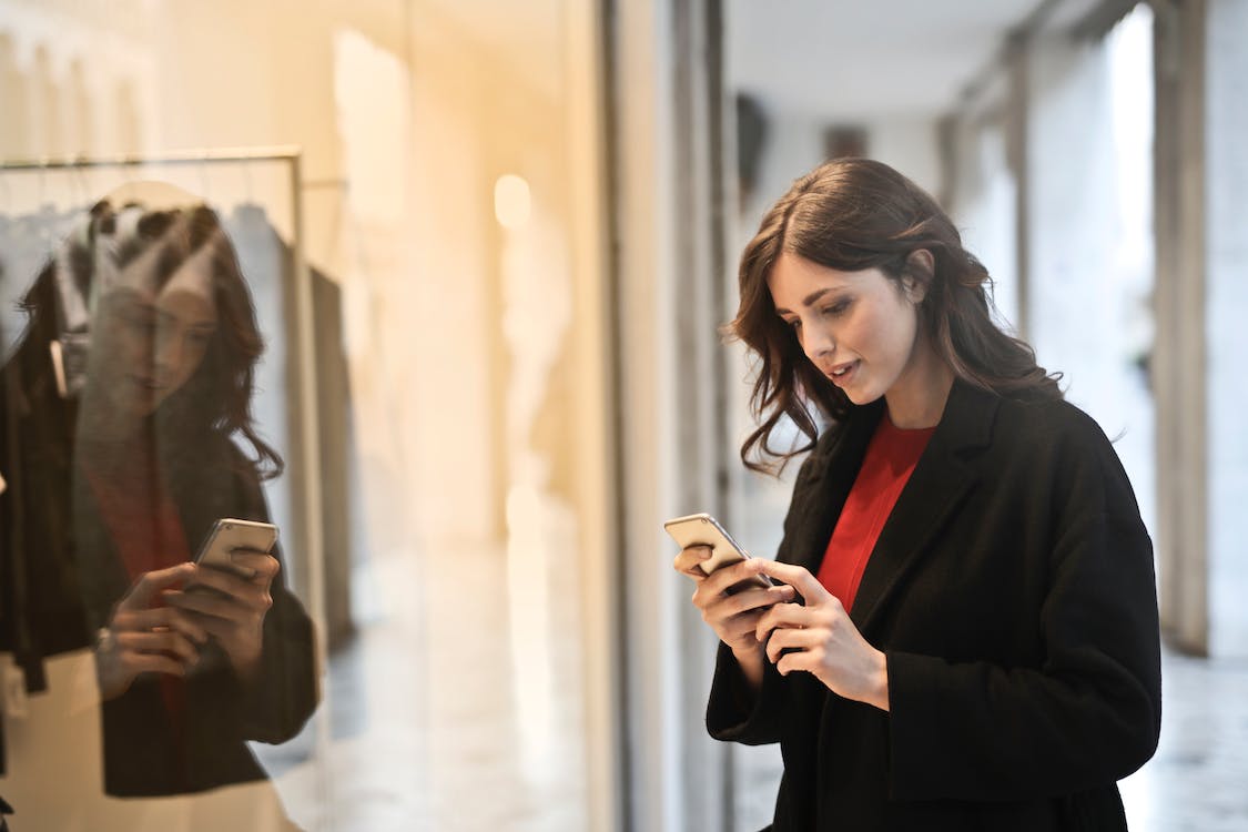 eCommerce customer checking prices on her phone. 