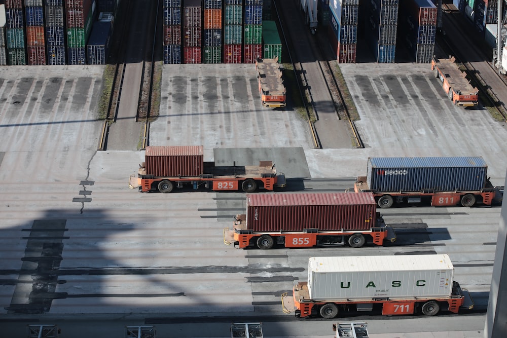 Trucks loaded with shipping containers