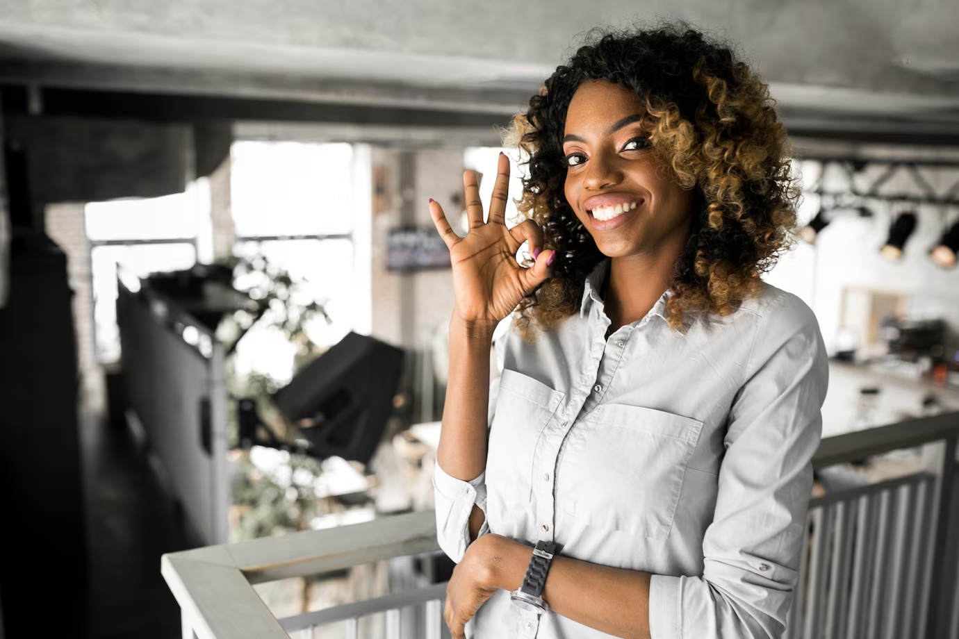 Happy eCommerce customer giving an okay sign.