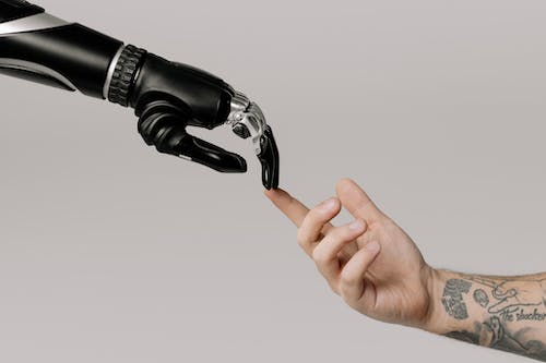 A robot and a human hand touching