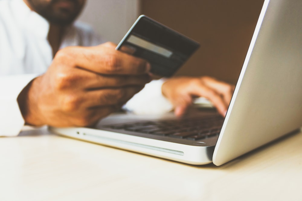 A person using a credit card to complete an eCommerce transaction.
