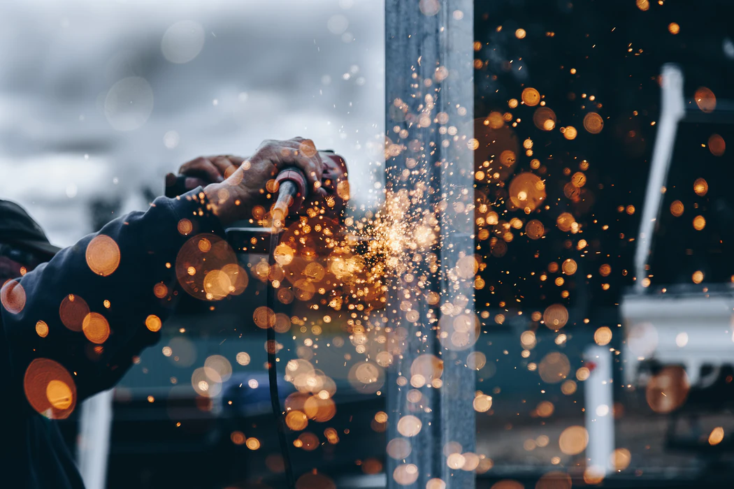 a man operates a saw inside a factory